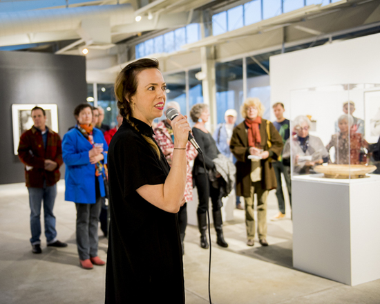 Curator Amy Owen speaking with guests in the Gatehouse Gallery