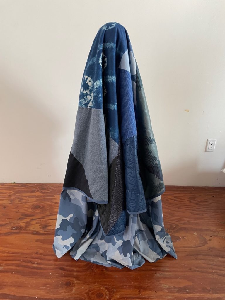 a blue and white dress on a wood floor