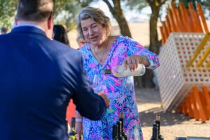 A person puring wine