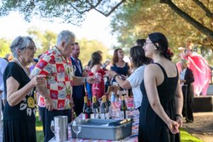 People tasting wine.